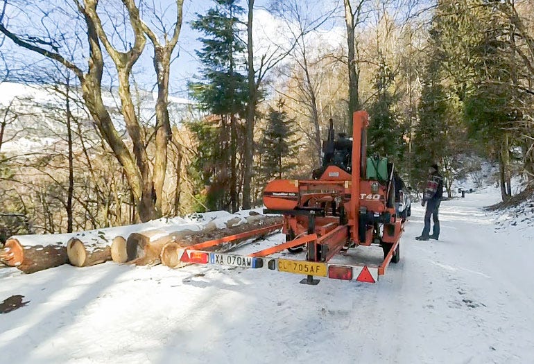 The sawmill is towed by a car